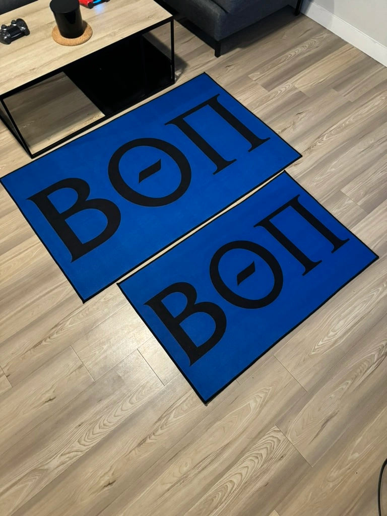 Officially Licensed Beta Theta Pi Custom Rugs Collection in medium and large in a living room.