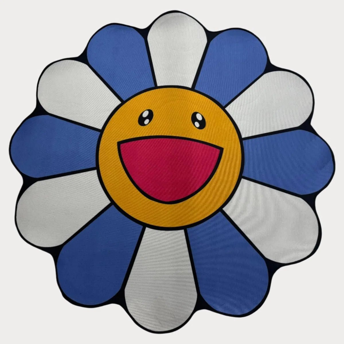 Blue Murakami Flower Rug with smiling face and detailed petals, laid flat on a clean white background.