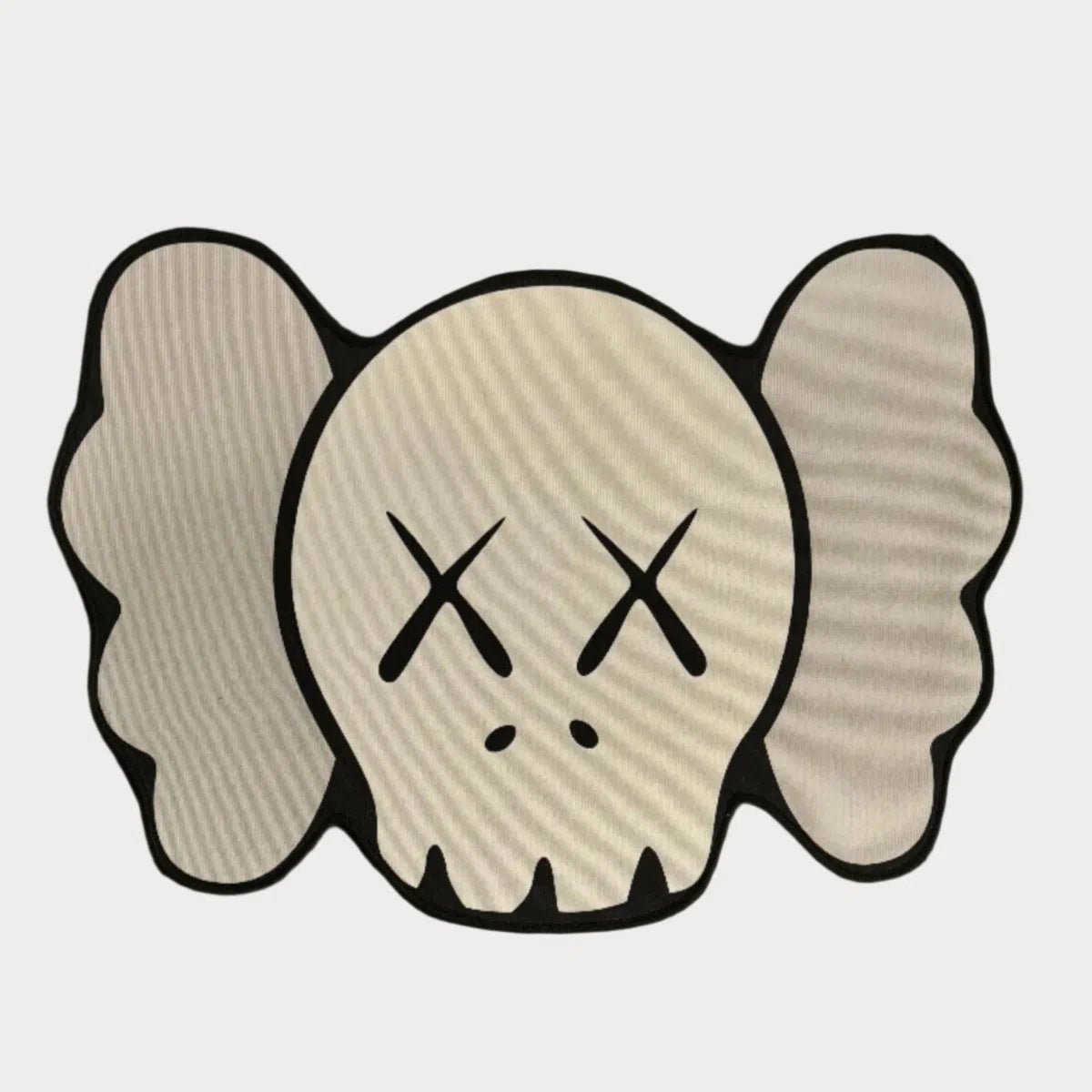 Grey tone KAWS Head Rug with concealed face, laid flat to show minimalist design.