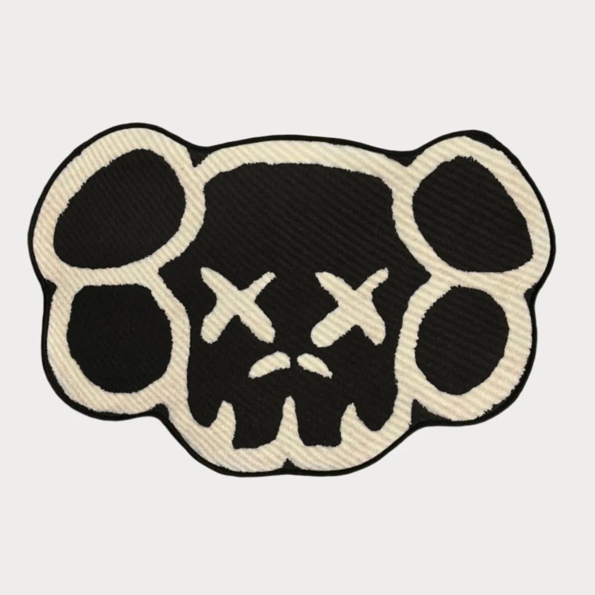 KAWS Head Rug in black and white, laid flat to show the concealed face design and monochrome contrast.
