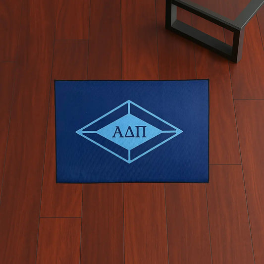 Alpha Delta Pi Letters Style | 3x2 ft Custom Rug by Sirenicate Rugs, prominently displayed on a vibrant dark hardwood floor background.