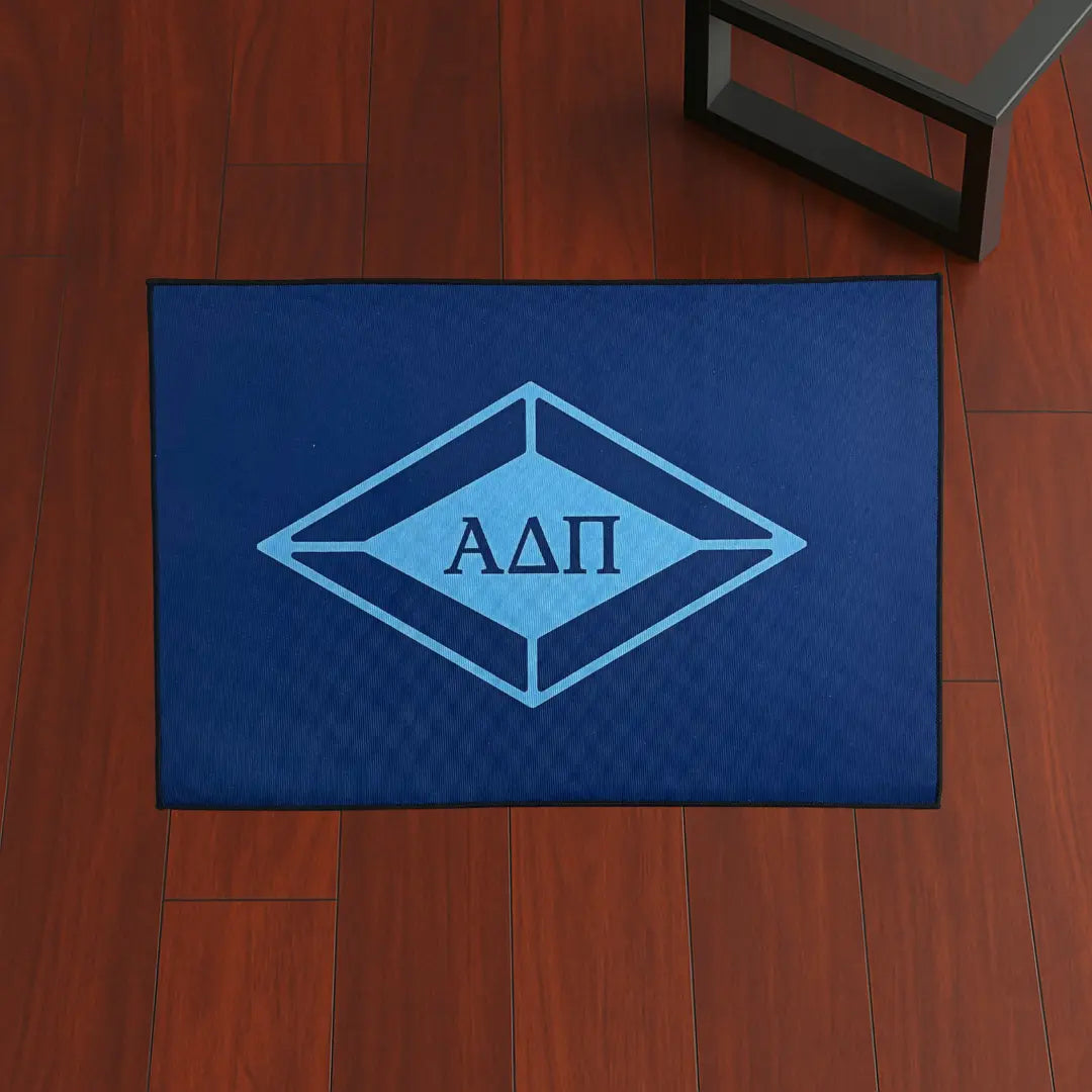 Alpha Delta Pi Letters Style | 4x2.5 ft Custom Rug by Sirenicate Rugs, prominently displayed on a vibrant dark hardwood floor background.