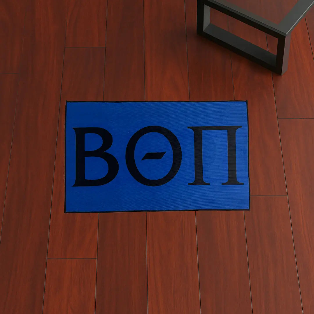 Custom Rug – Beta Theta Pi Letters Blue custom rug by Sirenicate Rugs, prominently displayed on a vibrant dark hardwood floor background.
