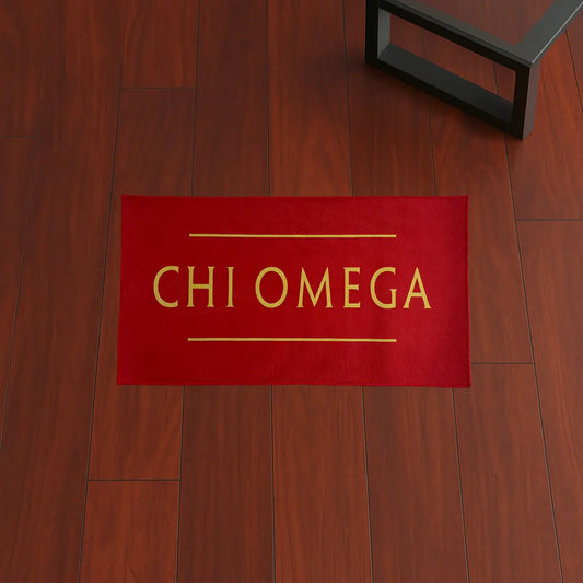 Custom Rug – Chi Omega Red & Yellow custom rug by Sirenicate Rugs, prominently displayed on a vibrant dark hardwood floor background.