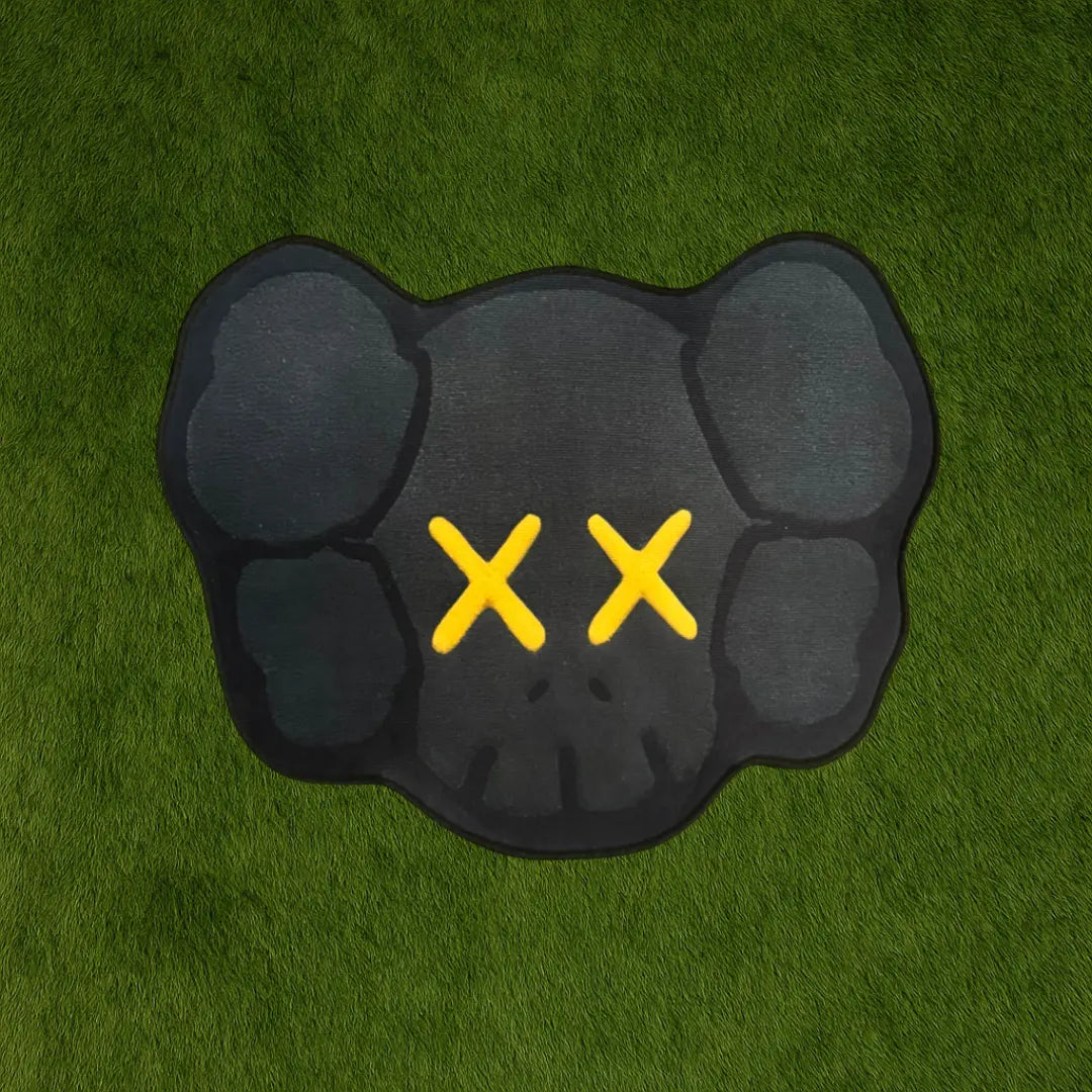 Custom Rug – KAWS Head Gold Accent Edition custom rug by Sirenicate Rugs, prominently displayed on a vibrant dark green turf background.