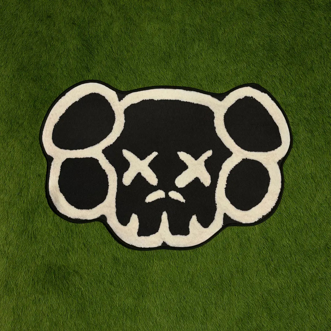 Custom Rug - KAWS Head Monochrome Edition Black & White custom rug by Sirenicate Rugs, prominently displayed on a vibrant dark green turf background.