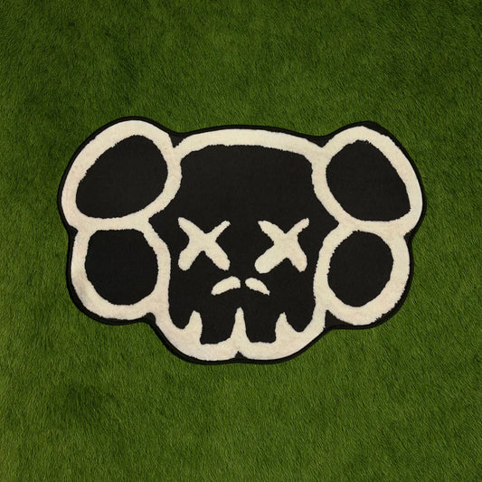 Custom Rug - KAWS Head Monochrome Edition Black & White custom rug by Sirenicate Rugs, prominently displayed on a vibrant dark green turf background.