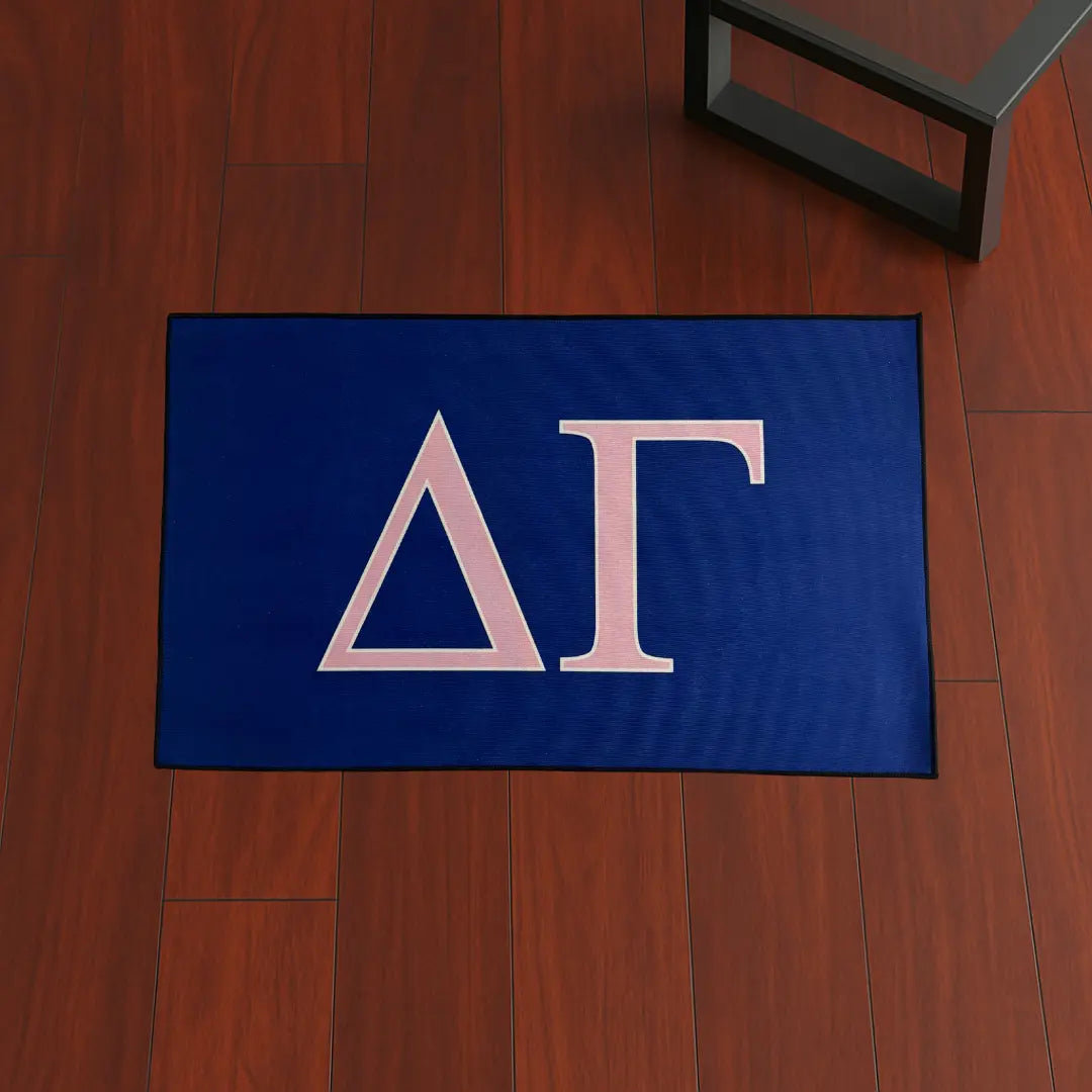 Custom Rug – Delta Gamma Pink & Blue custom rug by Sirenicate Rugs, prominently displayed on a vibrant dark hardwood floor background.