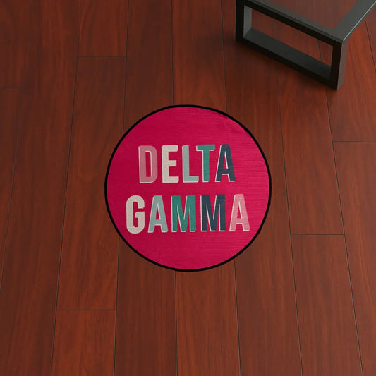 Custom Rug – Delta Gamma Pink Circle custom rug by Sirenicate Rugs, prominently displayed on a vibrant dark hardwood floor background.
