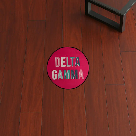 Custom Rug – Delta Gamma Pink Circle custom rug by Sirenicate Rugs, prominently displayed on a vibrant dark hardwood floor background.