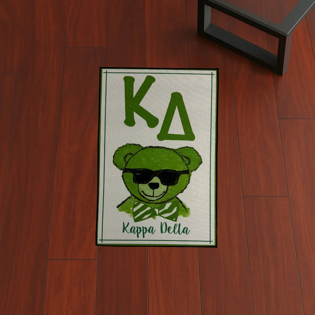 Custom Rug – Kappa Delta Green Bear custom rug by Sirenicate Rugs, prominently displayed on a vibrant dark hardwood floor background.