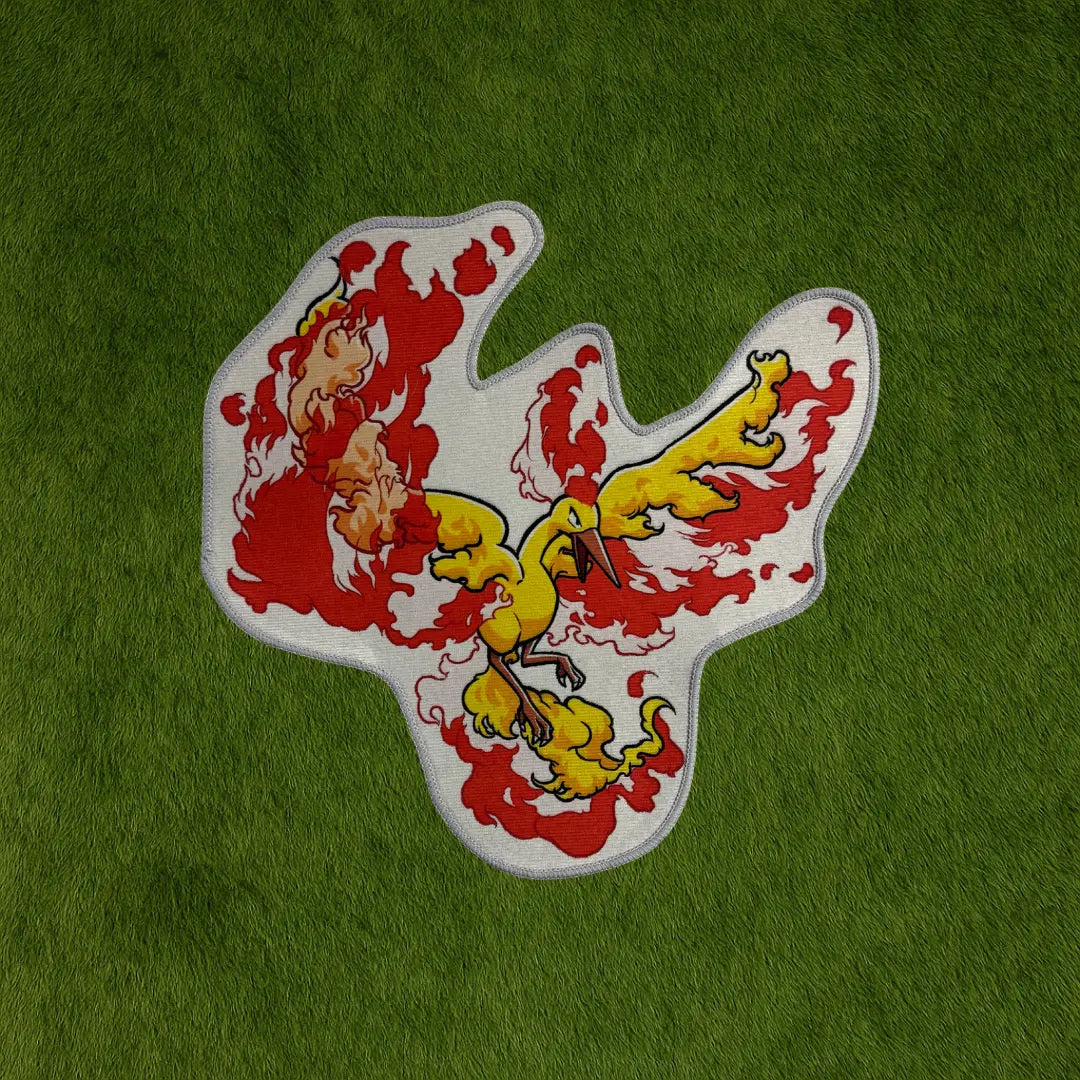 Moltres Rug – Legendary Firebird Pokemon Custom Rug for Collectors custom rug by Sirenicate Rugs, prominently displayed on a vibrant dark green turf background.