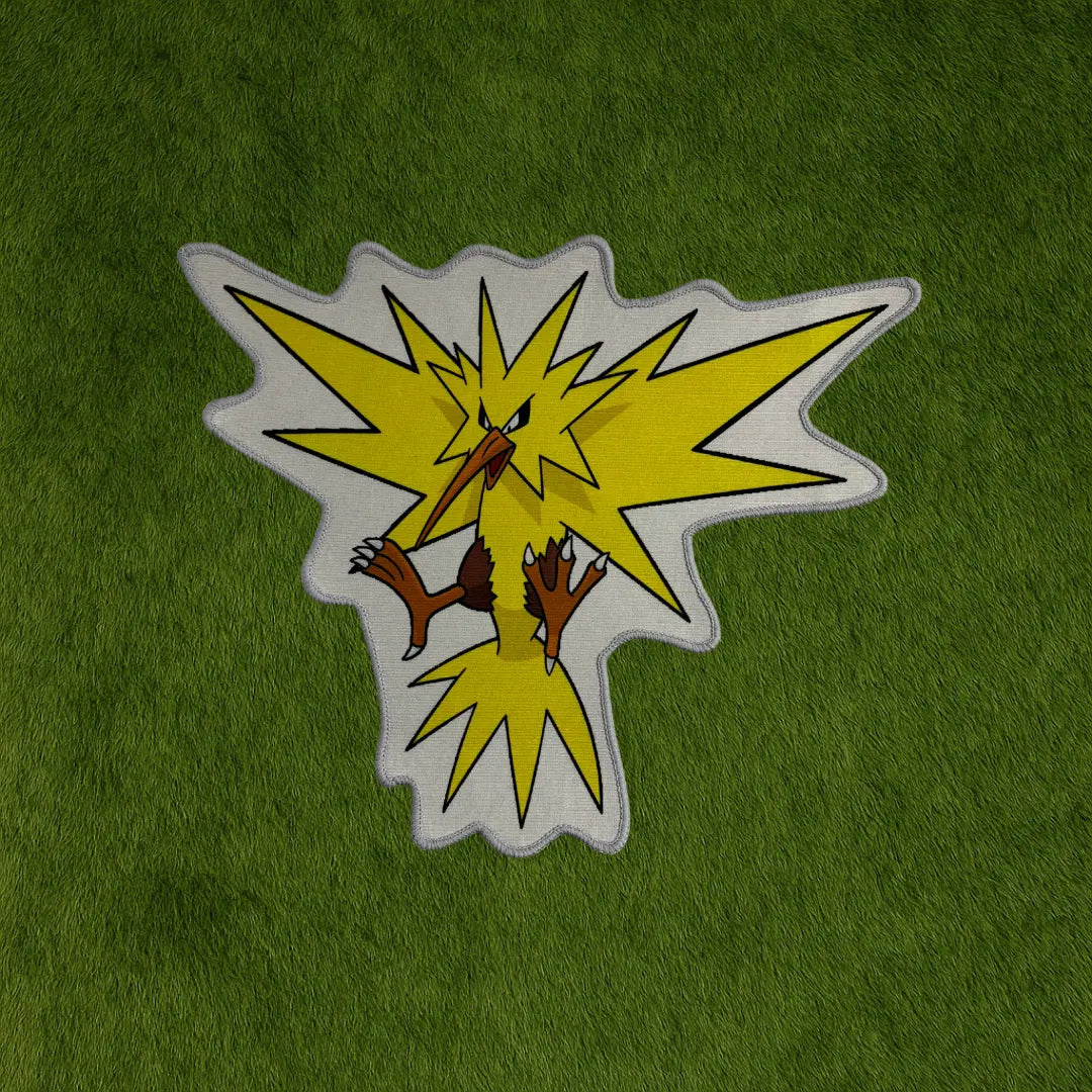 Zapdos Rug – Yellow Thunderbird Custom Pokémon Rug custom rug by Sirenicate Rugs, prominently displayed on a vibrant dark green turf background.