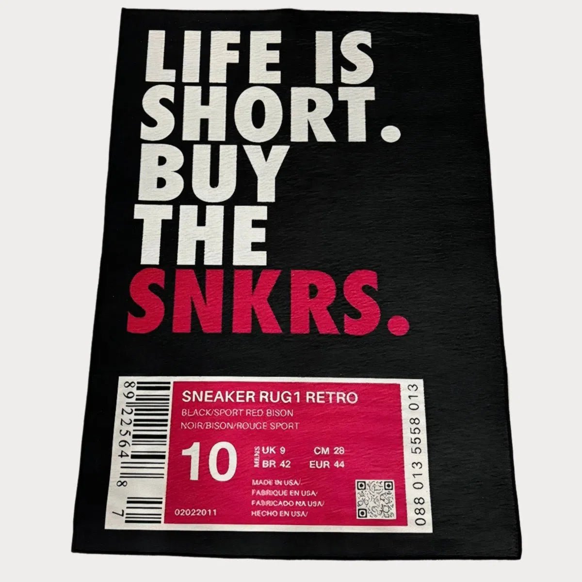 Sneaker Box Rug in bold hype pink, laid flat showing the label-style design and vibrant contrast.