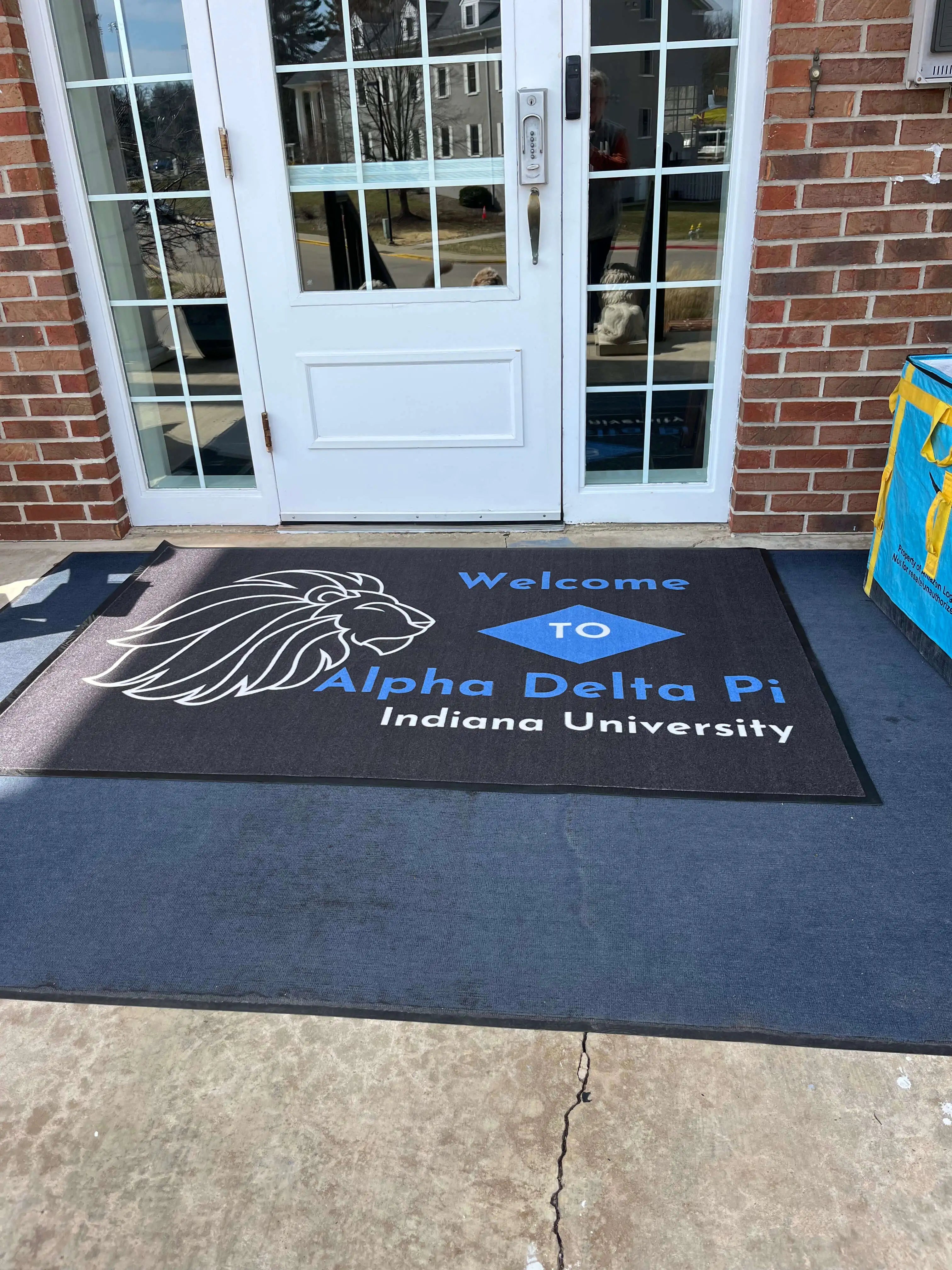 Alpha Delta Pi custom sorority rug for Indiana University chapter house with official letters and licensed crest design.