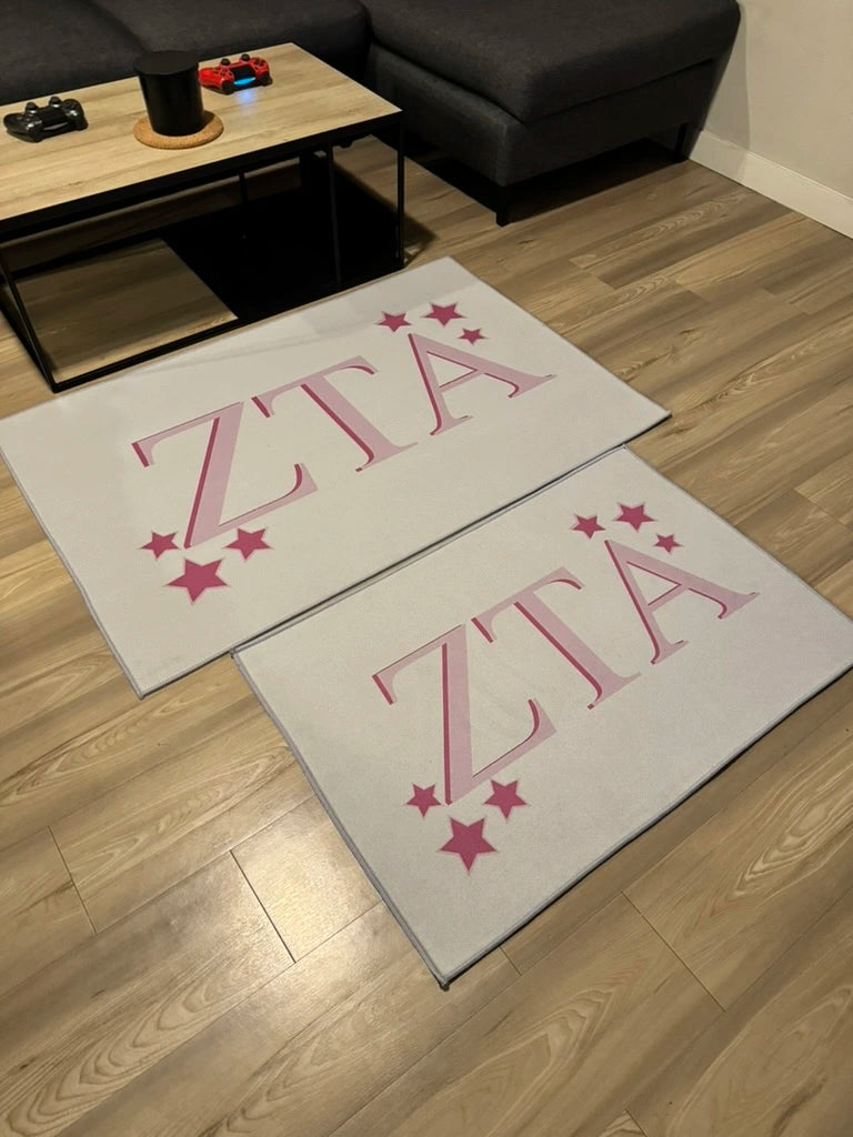 Officially Licensed Zeta Tau Alpha Custom Rugs Collection in medium and large in a living room.