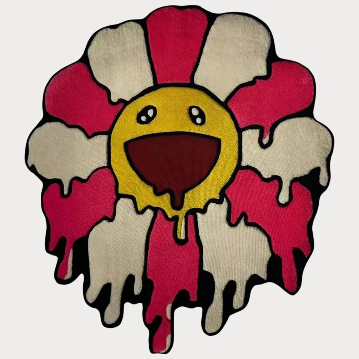 Pink Drip Flower Rug with melting pink petals and bold smiling face, laid flat on a clean background.