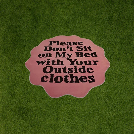 Custom Rug - Don't Sit on My Bed Pink with Text custom rug by Sirenicate Rugs, prominently displayed on a vibrant dark green turf background.
