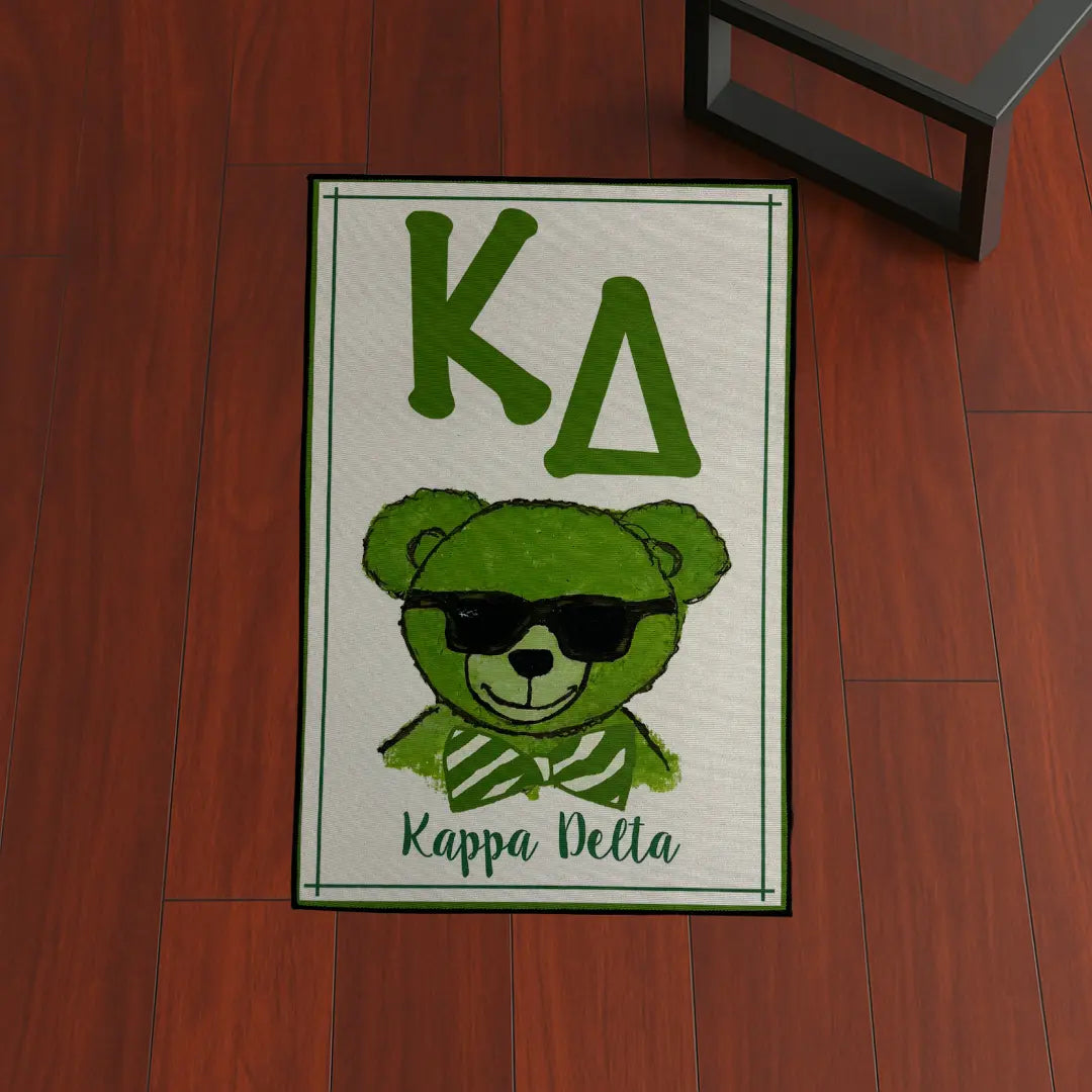 Custom Rug – Kappa Delta Green Bear custom rug by Sirenicate Rugs, prominently displayed on a vibrant dark hardwood floor background.
