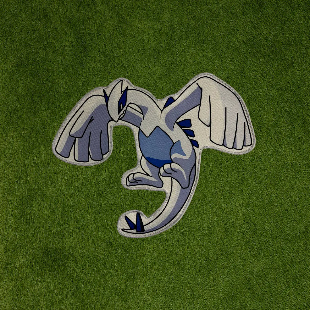 Lugia Rug – Legendary Bird Pokémon Collector Piece custom rug by Sirenicate Rugs, prominently displayed on a vibrant dark green turf background.