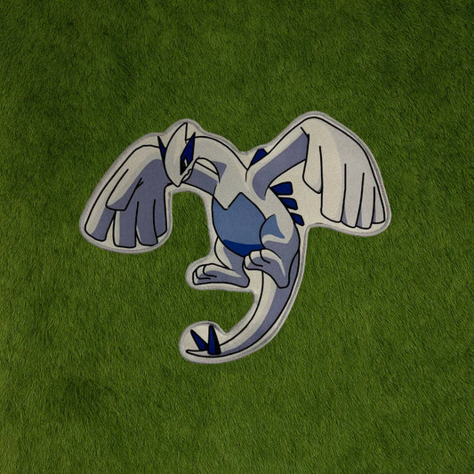 Lugia Rug – Legendary Bird Pokémon Collector Piece custom rug by Sirenicate Rugs, prominently displayed on a vibrant dark green turf background.