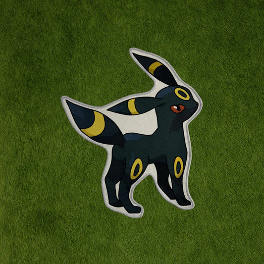 Umbreon Rug – Limited Edition Eevee Evolution Rug custom rug by Sirenicate Rugs, prominently displayed on a vibrant dark green turf background.